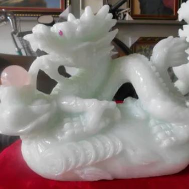 Green stone dragon releasing pearl statue