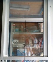 Self-rolling screen door