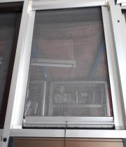 Self-rolling screen door