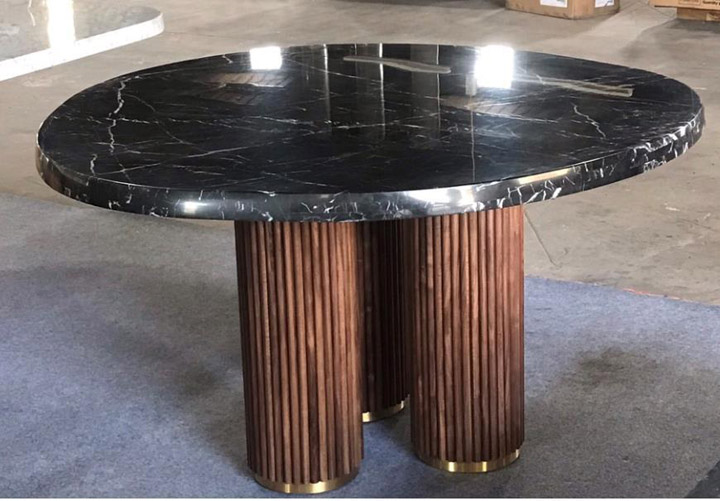 Round stone-top table with wooden legs